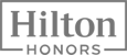 The image shows the "Hilton Honors" logo in grayscale, featuring a rectangular border around the text.