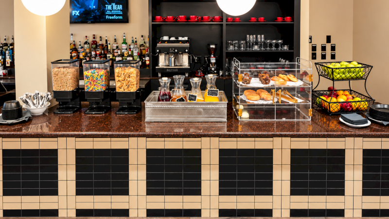 A hotel breakfast bar with snacks and beverages